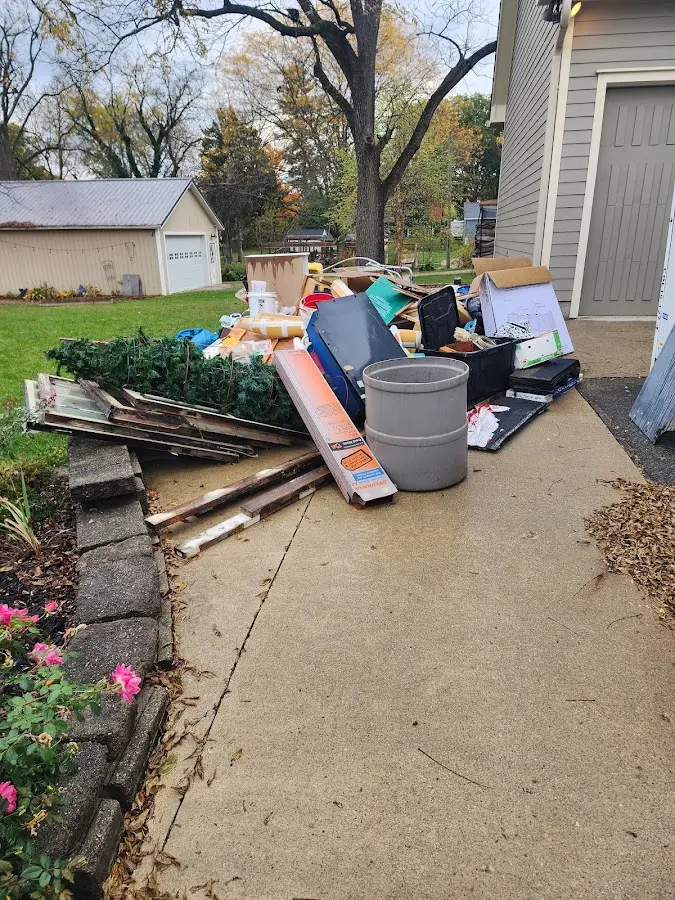 Dumpster being loaded with debris for 12 Yard Dumpster Rental in Milton
